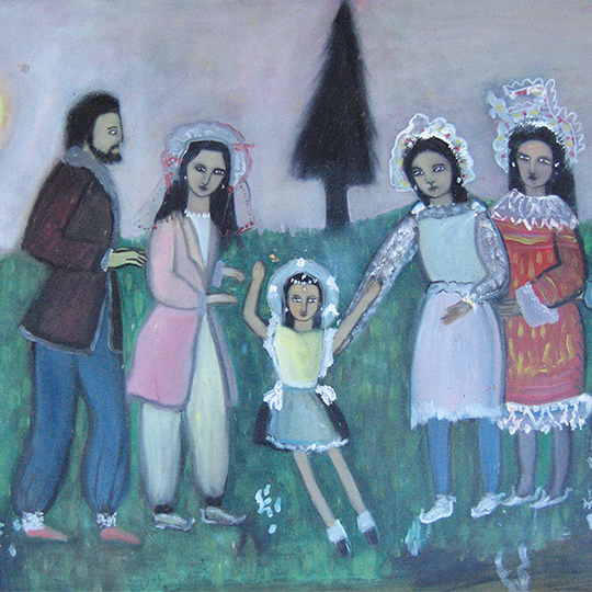 Family standing on hill with pine tree in party clothes